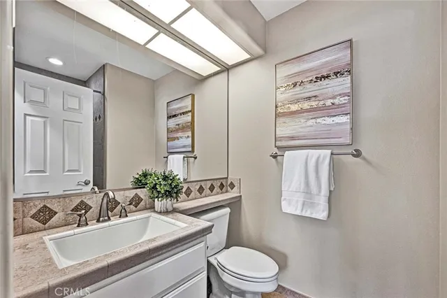 a bathroom with a sink a toilet and shower curtain