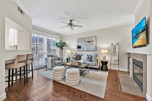 a living room with furniture fireplace and flat screen tv