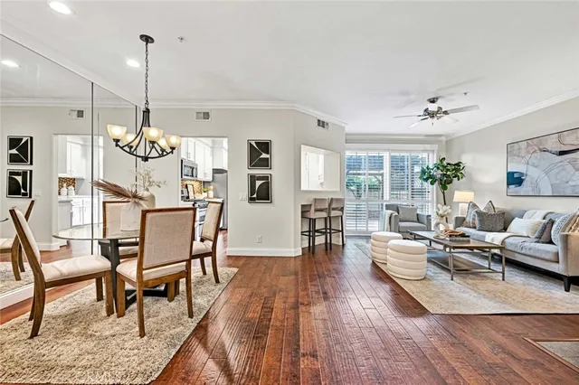 a living room with furniture dining table and a wooden floor
