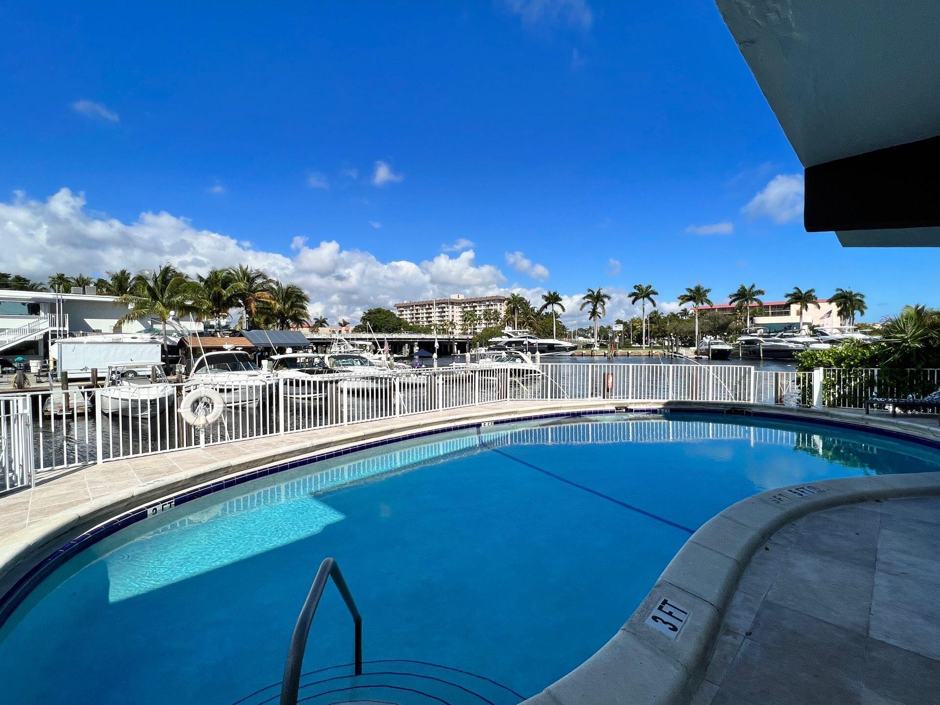 811 Southeast 22nd Avenue, Unit 12 Pompano Beach, FL 33062 - Photo 11 of 25 a view of a swimming pool with outdoor seating
