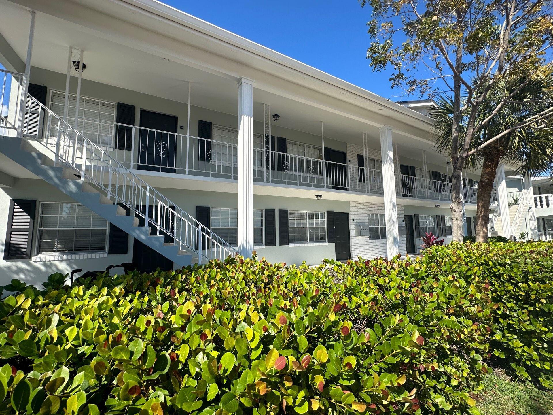 811 Southeast 22nd Avenue, Unit 12 Pompano Beach, FL 33062 - Photo 21 of 25 a pathway of a house with a large window and flower plants