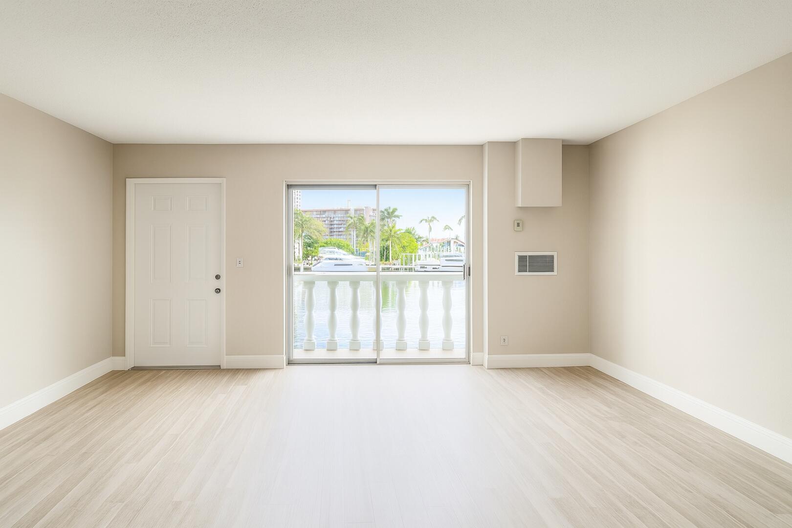 811 Southeast 22nd Avenue, Unit 12 Pompano Beach, FL 33062 - Photo 5 of 25 an empty room with wooden floor and windows