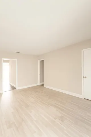 a view of an empty room and wooden floor