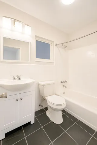 a bathroom with a sink toilet a mirror and shower