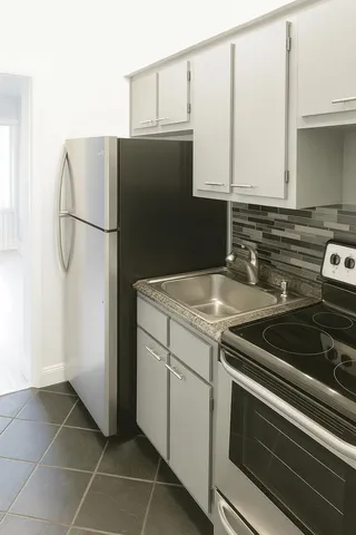 a close view of a stove top oven and cabinets