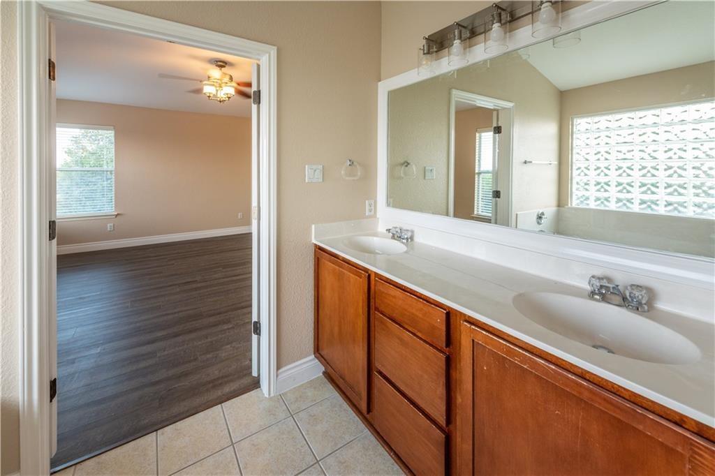 12017 Springs Head Loop Austin, TX 78717 - Photo 16 of 25 Double vanity and a deep soaking tub create a restful primary bath oasis.