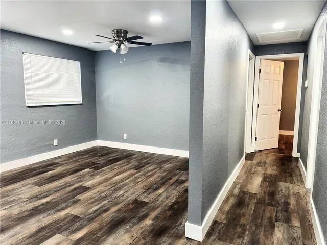 a view of a livingroom with a hall and a ceiling fan
