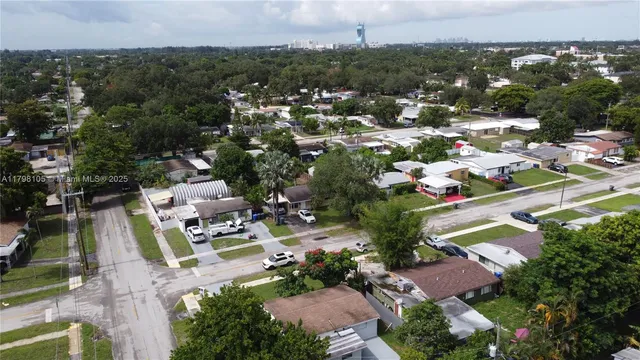 an aerial view of residential houses with outdoor space and swimming pool