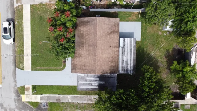 an aerial view of a house with a garden and plants