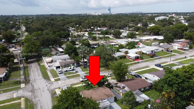 an aerial view of a houses with a yard