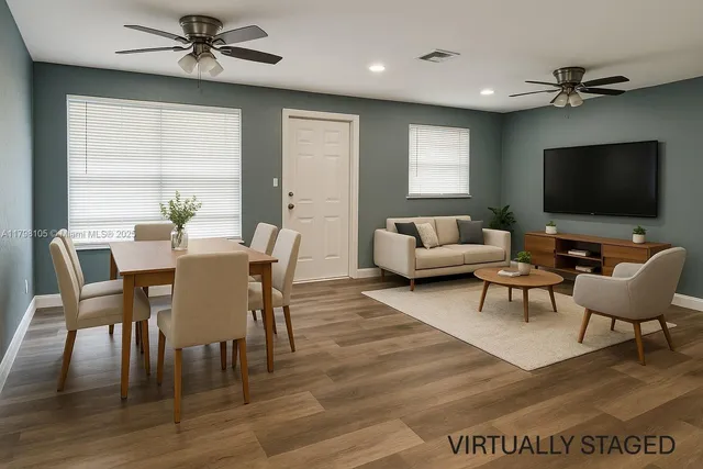 a living room with furniture wooden floor and a window