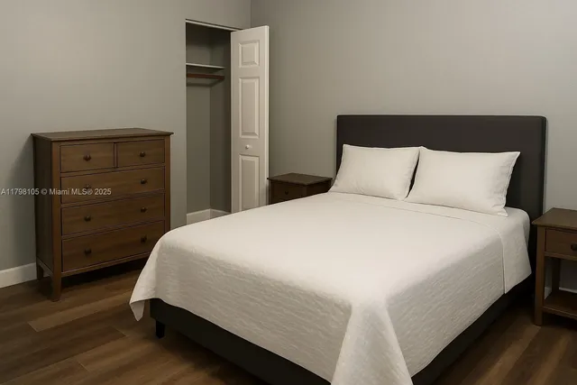 a bed sitting in a bedroom with dresser