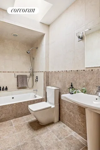 a bedroom with bed couch and window