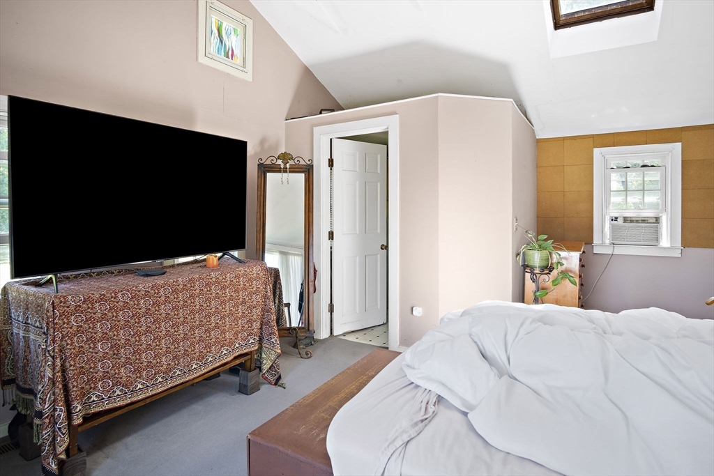 2 Highfield Road Newbury, MA 01951 - Photo 26 of 36 a bedroom with a bed table and flat screen tv