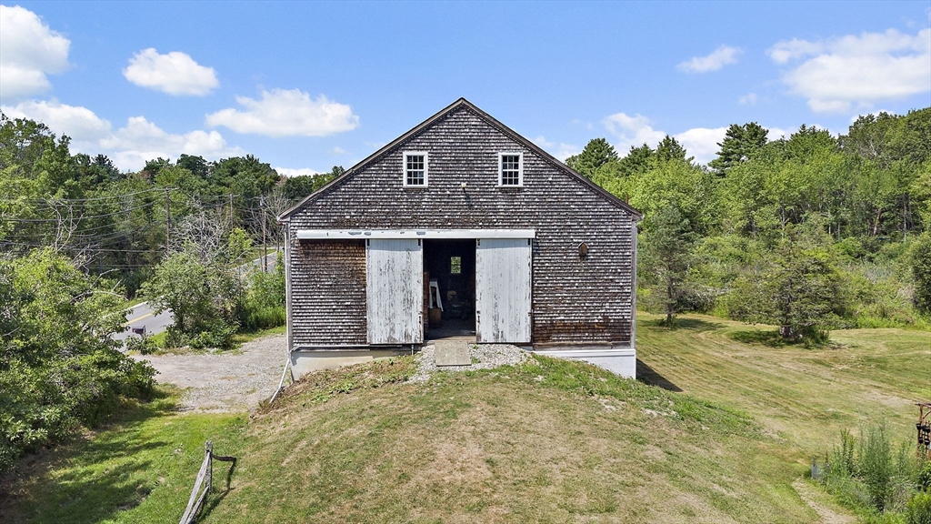 2 Highfield Road Newbury, MA 01951 - Photo 8 of 36 a front view of a house with a garden and yard