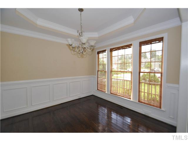 736 Bennett Ridge Court Wake Forest, NC 27587 - Photo 4 of 19 Elegant formal dining room with gleaming hardwoods, luxurious trey ceiling, and beautiful wainscoting