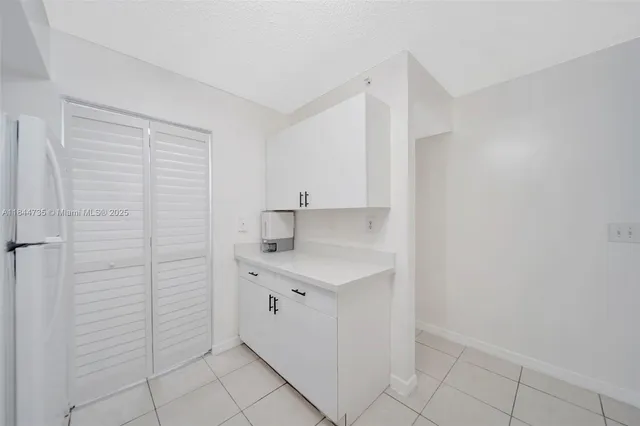 a kitchen with a sink cabinets and a window