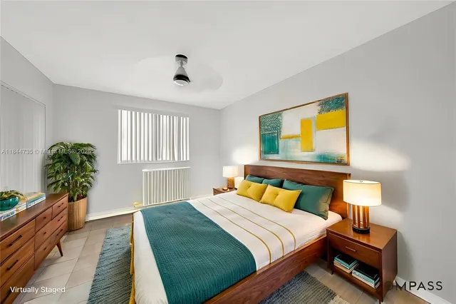 a bedroom with a bed and a potted plant