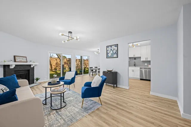 a living room with furniture and a chandelier