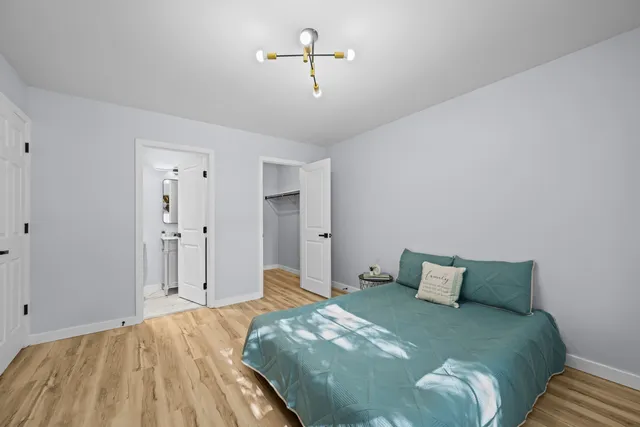 a bedroom with a bed and cabinets