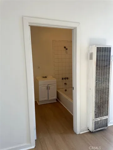 a bathroom with a tub sink and mirror