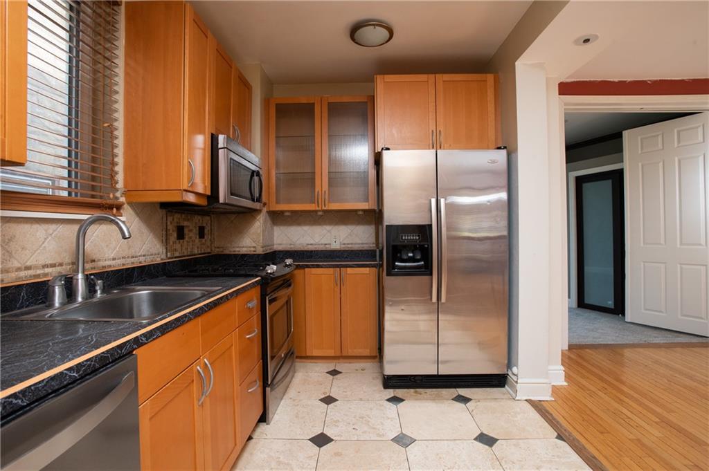 15 Frazier Avenue McKees Rocks, PA 15136 - Photo 6 of 11 a kitchen with stainless steel appliances granite countertop a refrigerator a sink and a stove