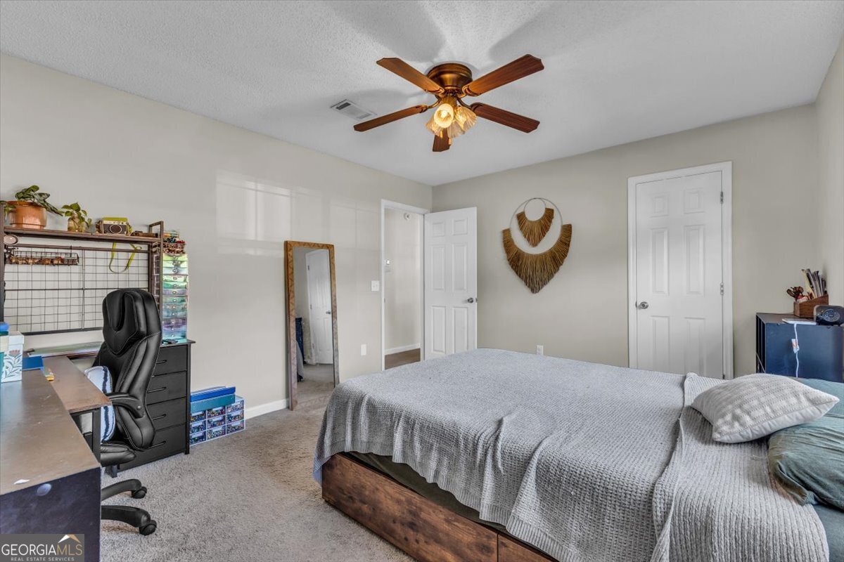 1244 Chinook Way Hinesville, GA 31313 - Photo 15 of 27 a bedroom with a bed and a chandelier