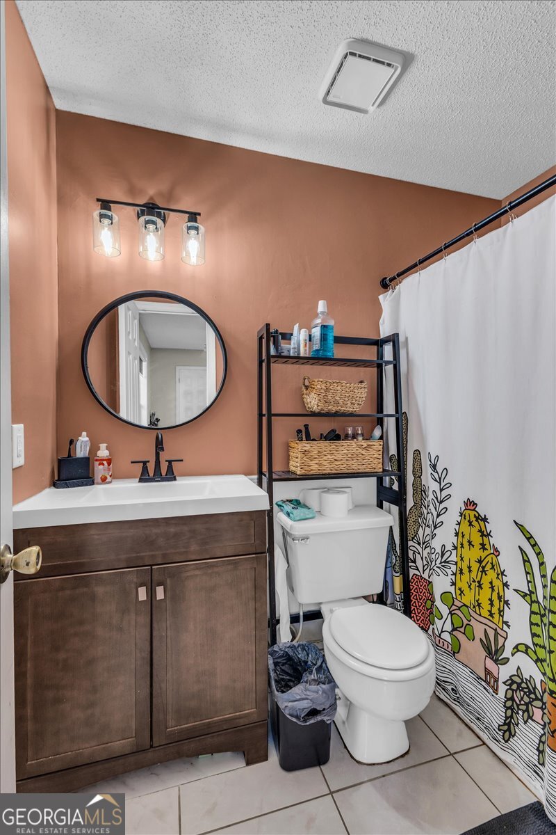 1244 Chinook Way Hinesville, GA 31313 - Photo 17 of 27 a bathroom with a toilet a sink and mirror