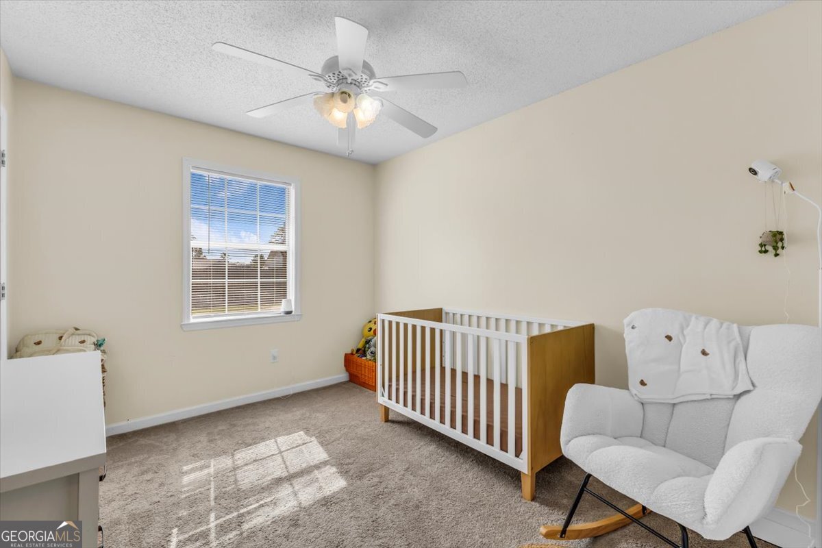 1244 Chinook Way Hinesville, GA 31313 - Photo 18 of 27 a living room with furniture and a chandelier