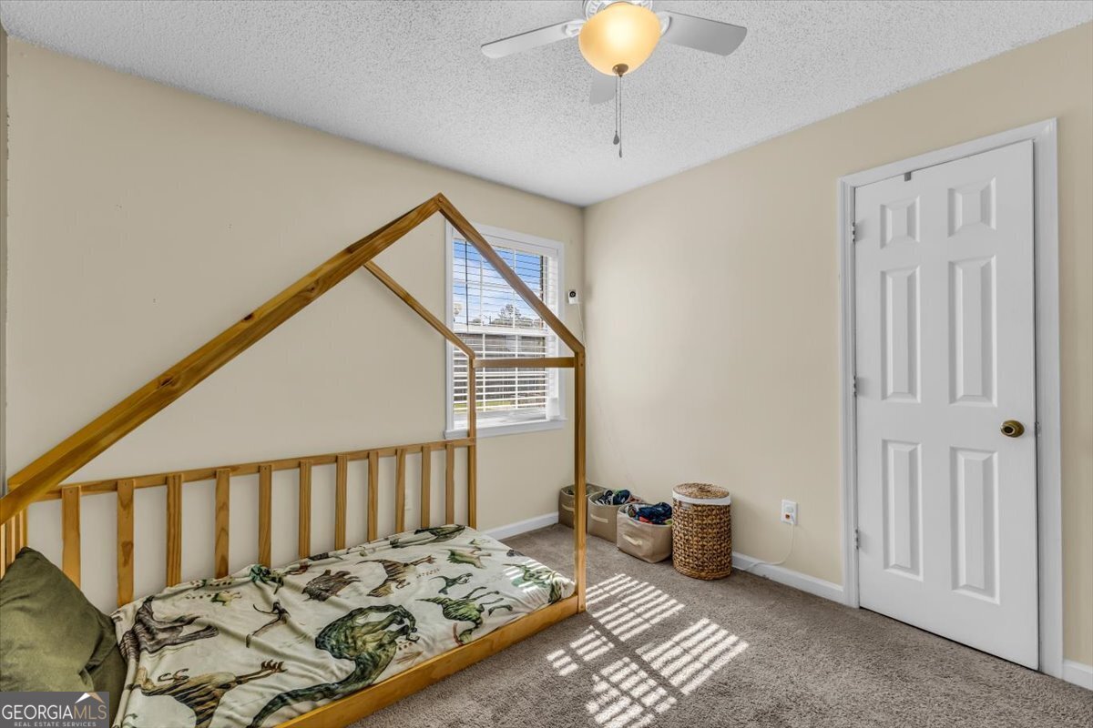 1244 Chinook Way Hinesville, GA 31313 - Photo 21 of 27 a bedroom with bed and wooden floor