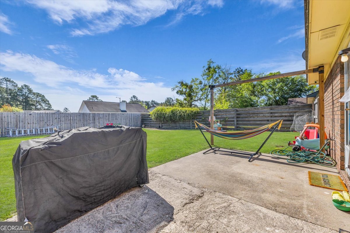 1244 Chinook Way Hinesville, GA 31313 - Photo 25 of 27 a view of a park with swings and slides