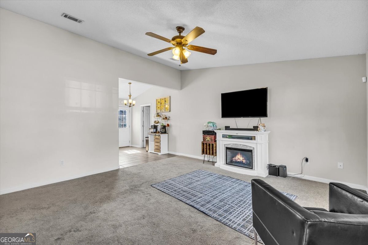 1244 Chinook Way Hinesville, GA 31313 - Photo 8 of 27 a living room with furniture and a flat screen tv
