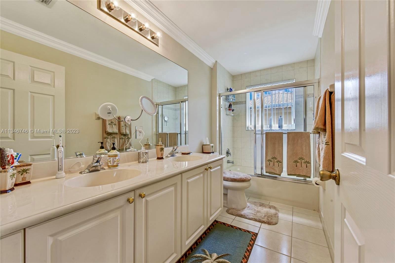 16392 Southwest 29th Street Miramar, FL 33027 - Photo 13 of 30 a bathroom with a double vanity sink mirror and toilet