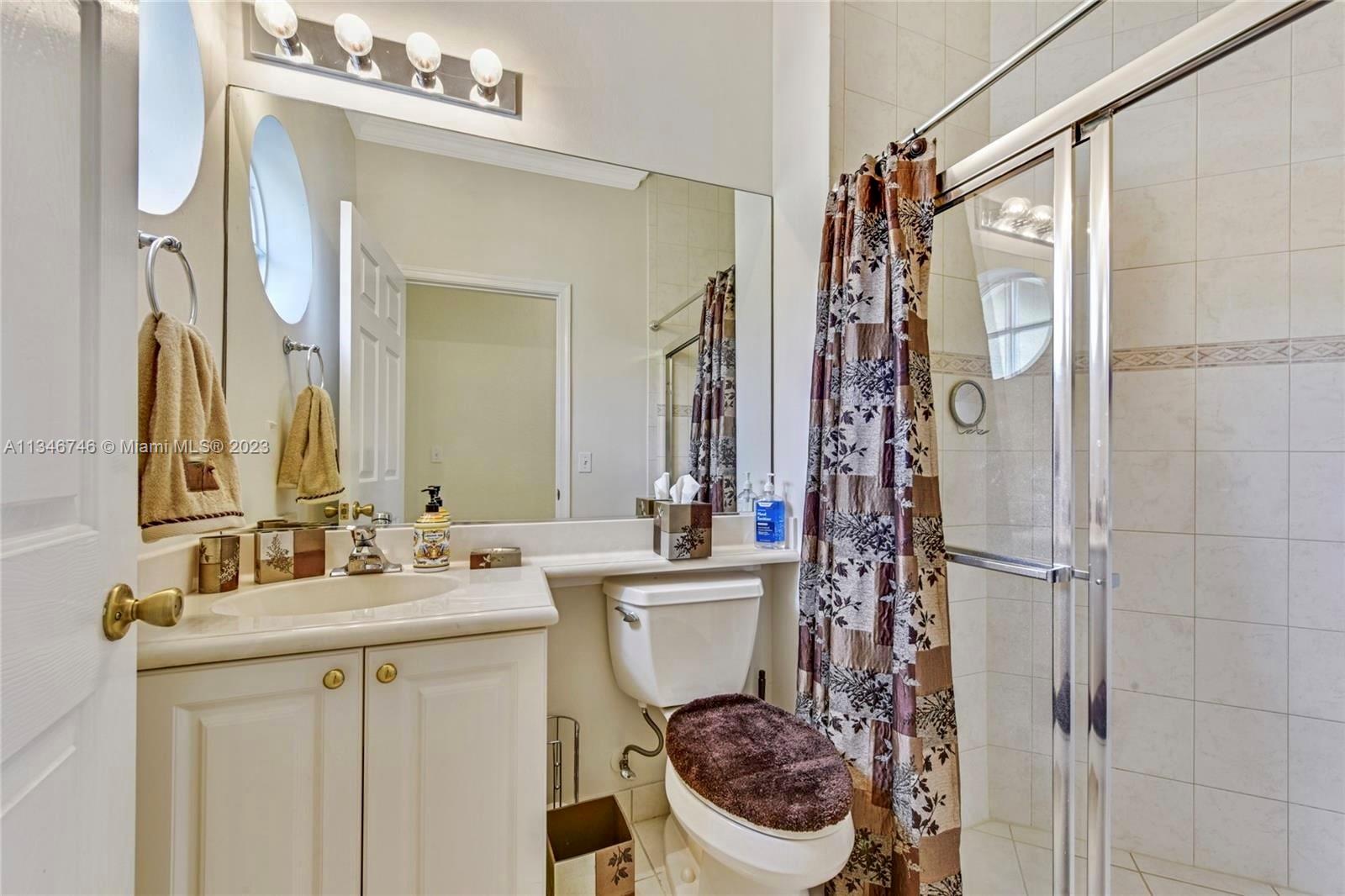 16392 Southwest 29th Street Miramar, FL 33027 - Photo 15 of 30 a bathroom with a sink vanity mirror and toilet
