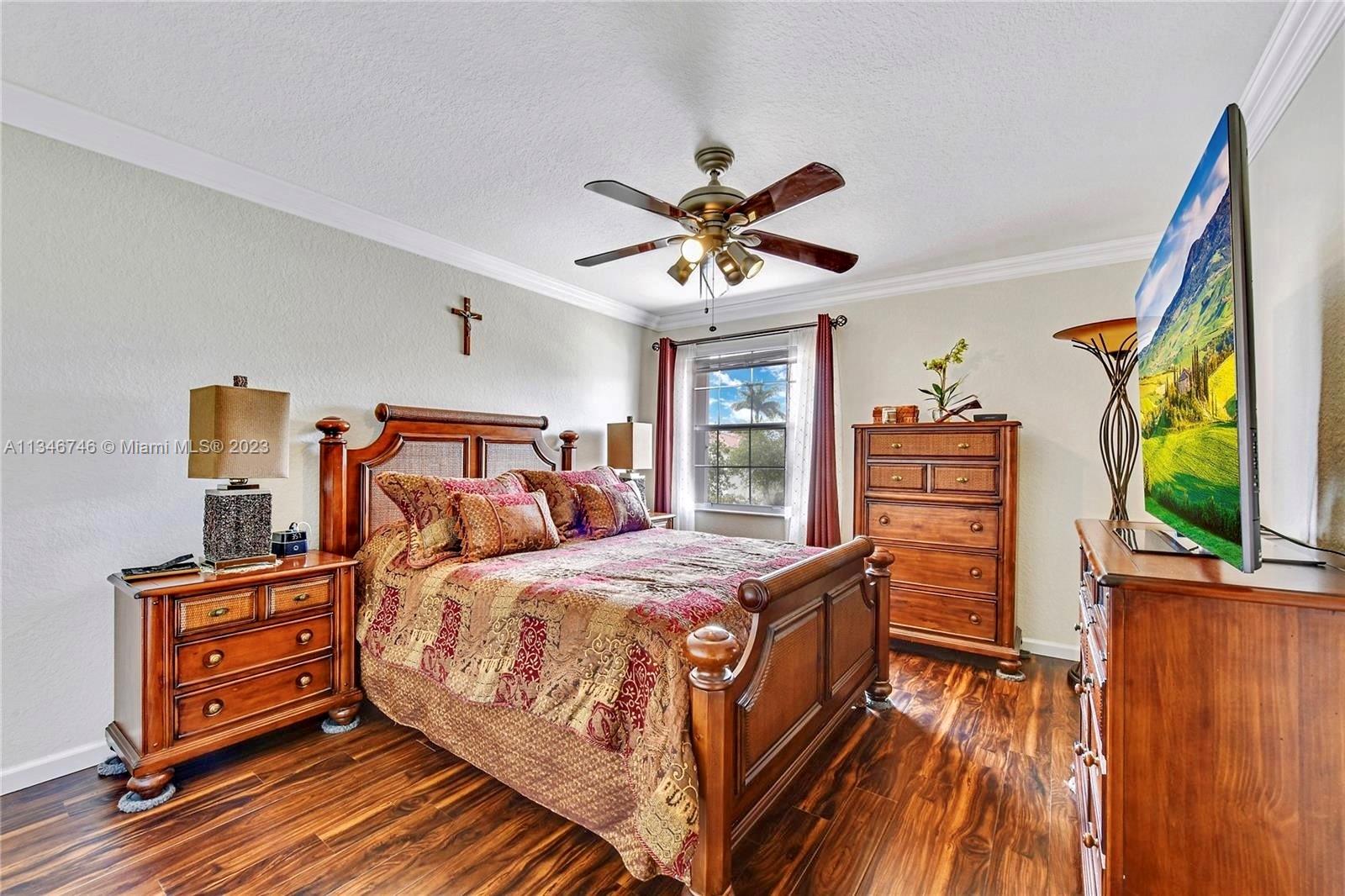 16392 Southwest 29th Street Miramar, FL 33027 - Photo 16 of 30 a bedroom with a bed and a flat screen tv