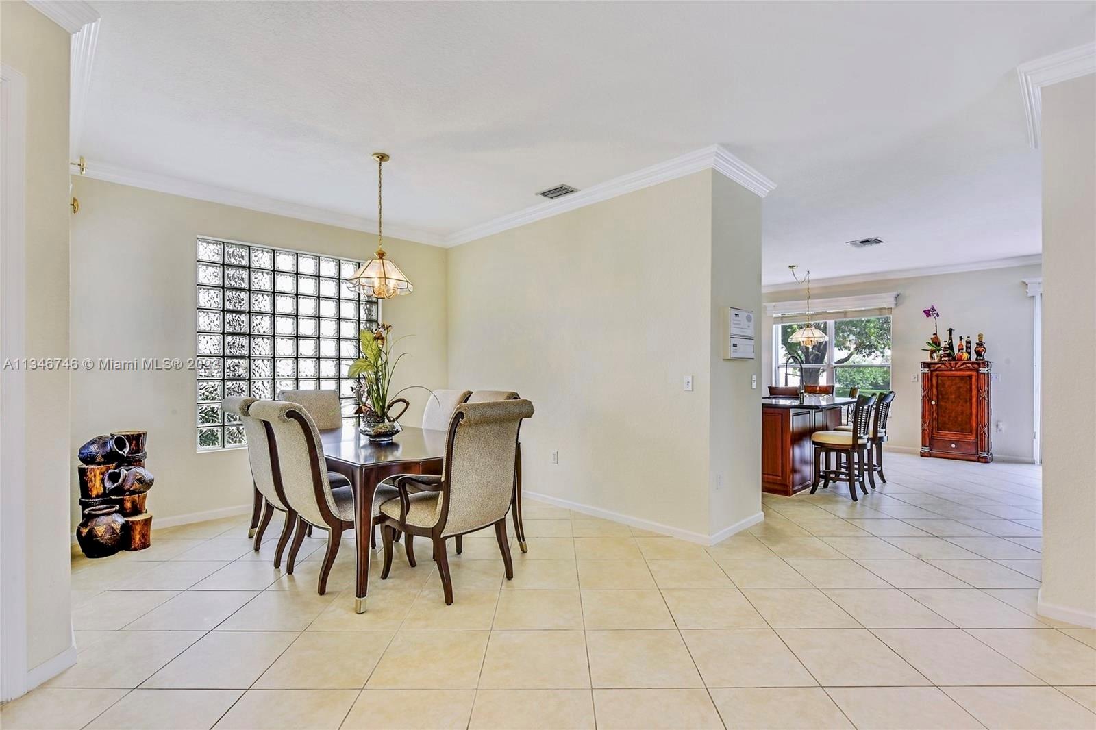 16392 Southwest 29th Street Miramar, FL 33027 - Photo 19 of 30 a dining room with furniture and chandelier