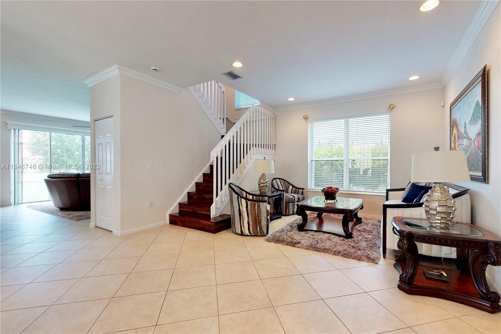 16392 Southwest 29th Street Miramar, FL 33027 - Photo 2 of 30 a living room with furniture and a potted plant