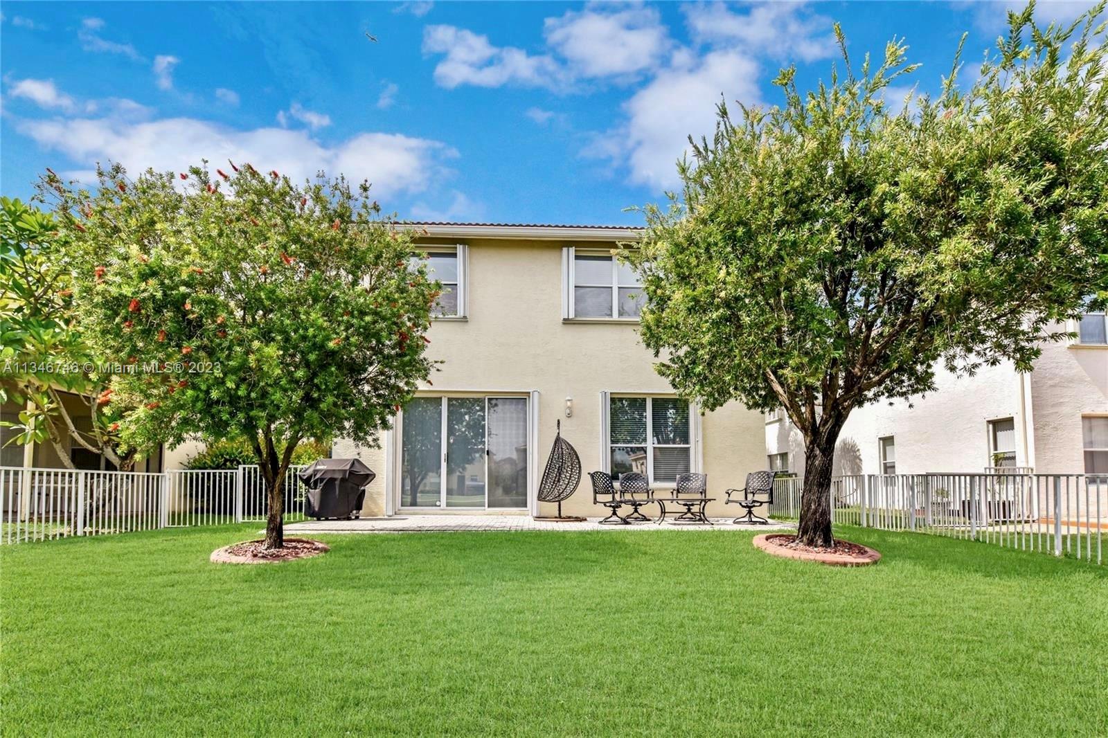 16392 Southwest 29th Street Miramar, FL 33027 - Photo 25 of 30 a front view of a house with a garden