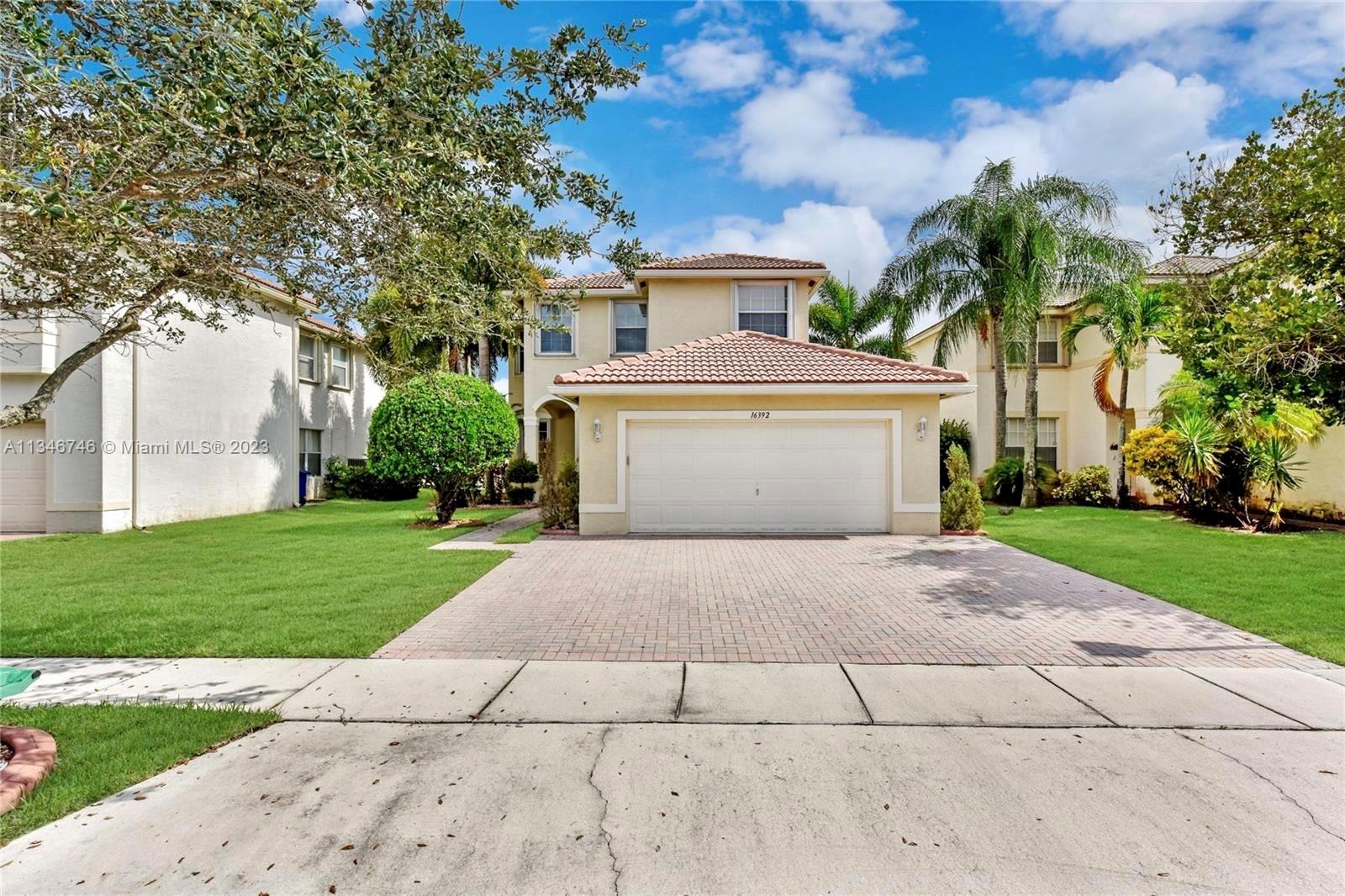 16392 Southwest 29th Street Miramar, FL 33027 - Photo 30 of 30 a view of a house with a yard and large tree