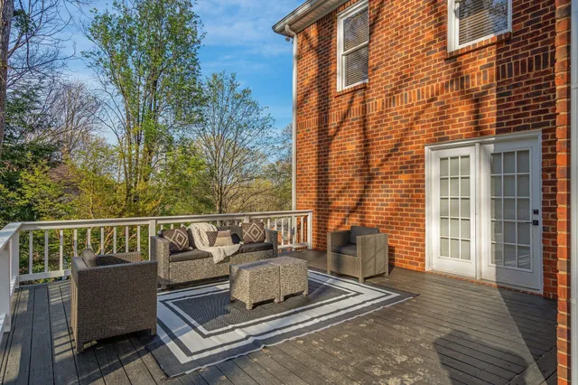 a view of a roof deck with couches and wooden floor