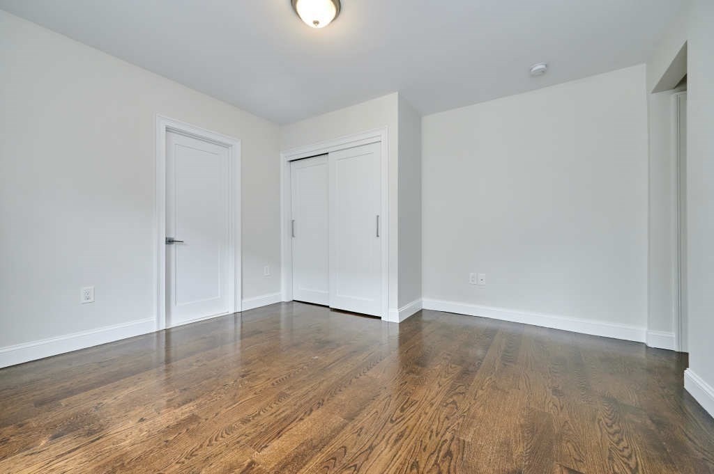 63 Bradford Road, Unit B Watertown, MA 02472 - Photo 13 of 24 an empty room with wooden floor
