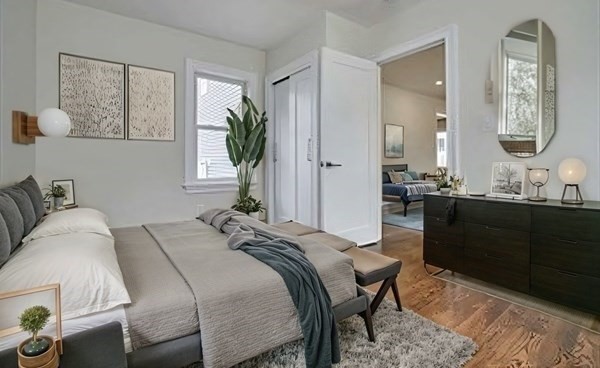 63 Bradford Road, Unit B Watertown, MA 02472 - Photo 18 of 24 a bedroom with a bed and a mirror