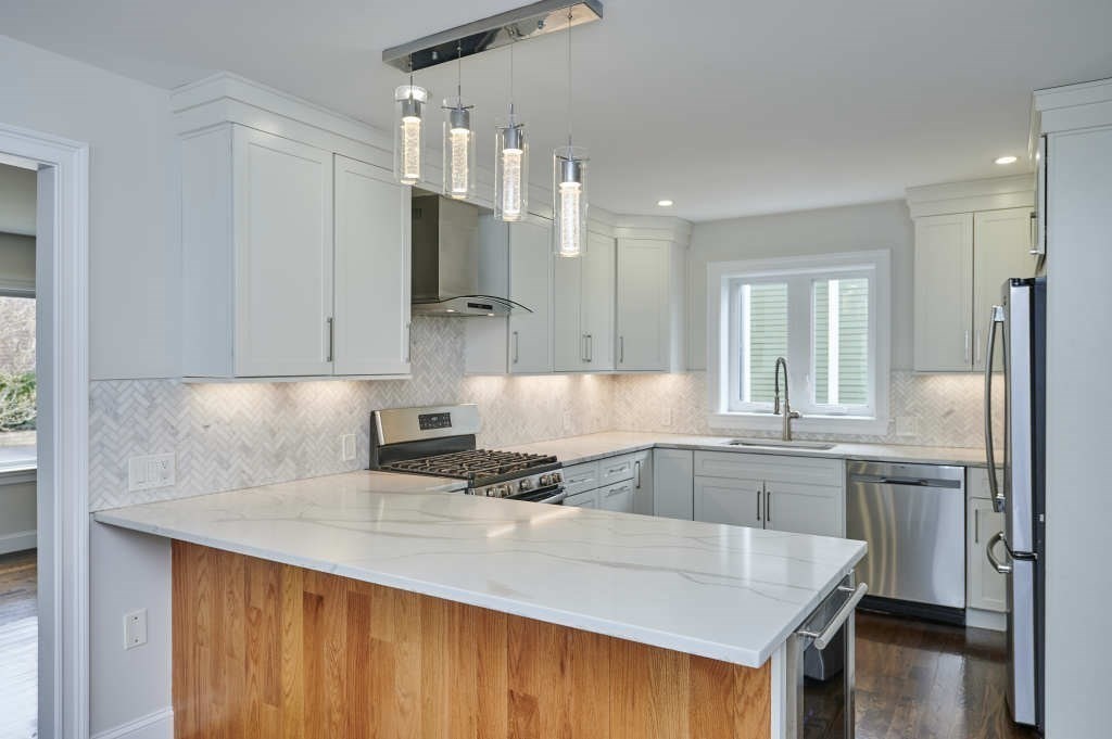 63 Bradford Road, Unit B Watertown, MA 02472 - Photo 3 of 24 a kitchen with stainless steel appliances granite countertop a sink stove and refrigerator
