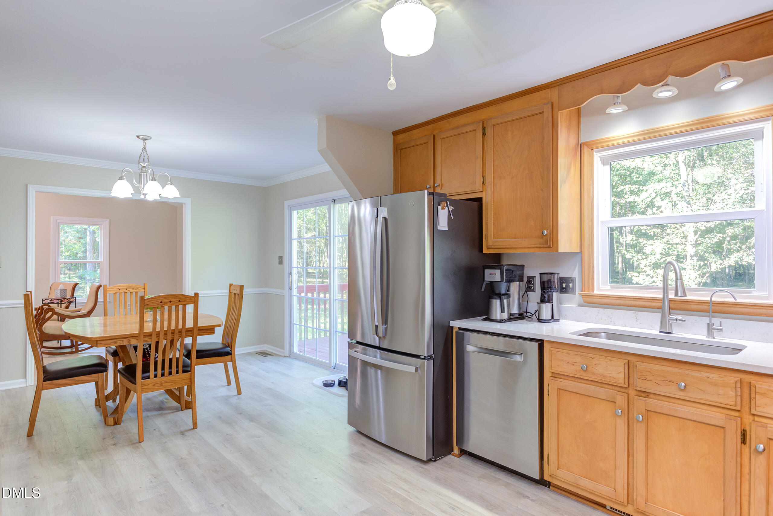 2120 New Sharon Church Road Hillsborough, NC 27278 - Photo 16 of 51 a kitchen with stainless steel appliances a dining table chairs refrigerator and sink