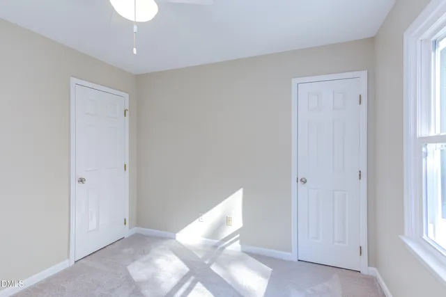 a view of deck with furniture and umbrella