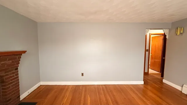 a view of small space with wooden floor and a sink