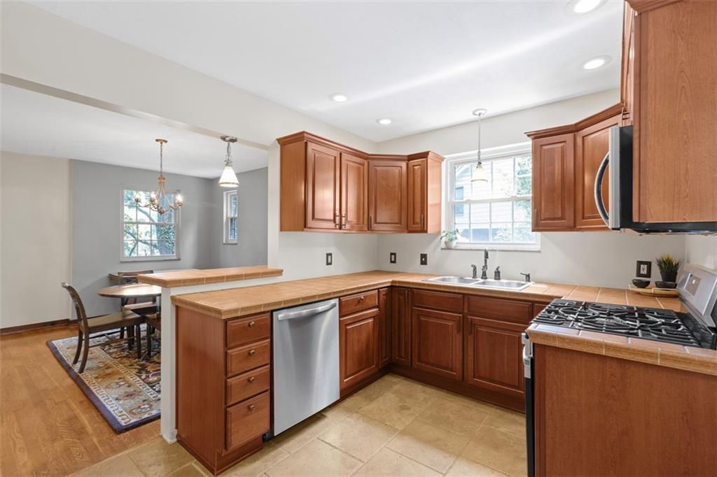 21 Bryn Mawr Road Pittsburgh, PA 15221 - Photo 15 of 42 a kitchen with stainless steel appliances granite countertop a sink stove and cabinets