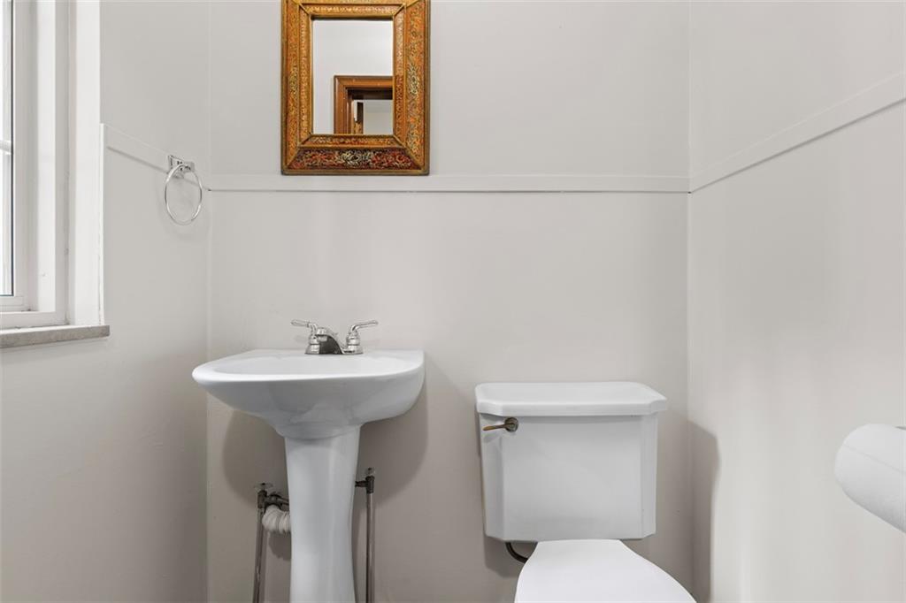 21 Bryn Mawr Road Pittsburgh, PA 15221 - Photo 16 of 42 a bathroom with a sink a toilet and mirror
