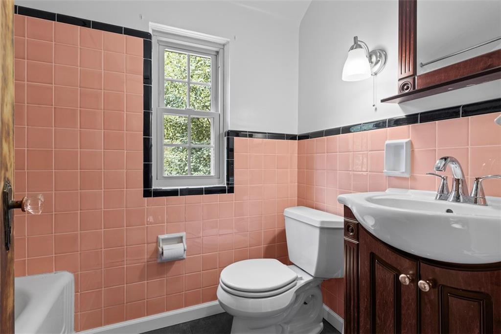 21 Bryn Mawr Road Pittsburgh, PA 15221 - Photo 20 of 42 a bathroom with a sink a toilet and mirror