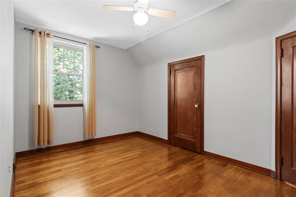 21 Bryn Mawr Road Pittsburgh, PA 15221 - Photo 22 of 42 a view of an empty room with wooden floor and a window